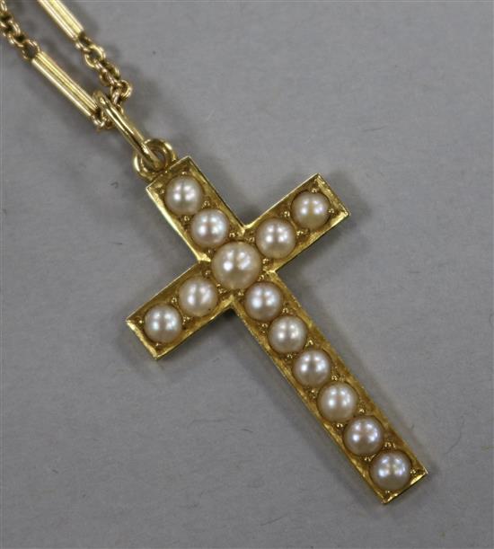 A 15ct yellow gold cross set with seed pearls on 14ct yellow gold chain.